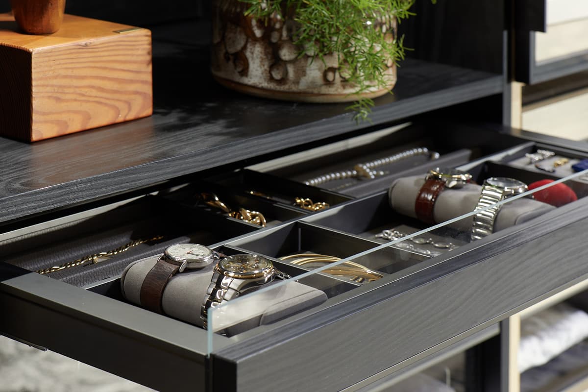 Jewelry detail inserts for watches with padded cushions in dark wood finish by California Closets