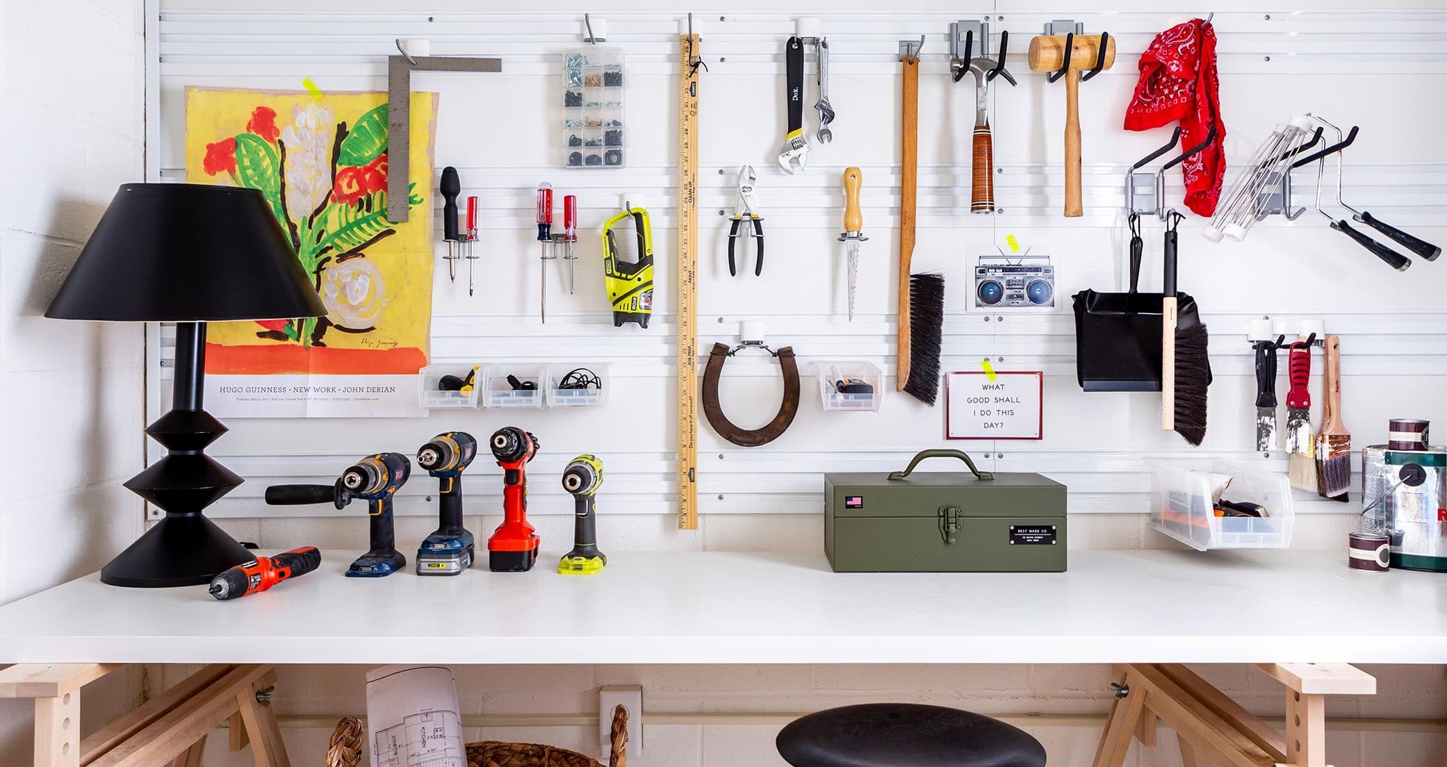 Custom garage workbench against wall with fusion wall track system by California Closets