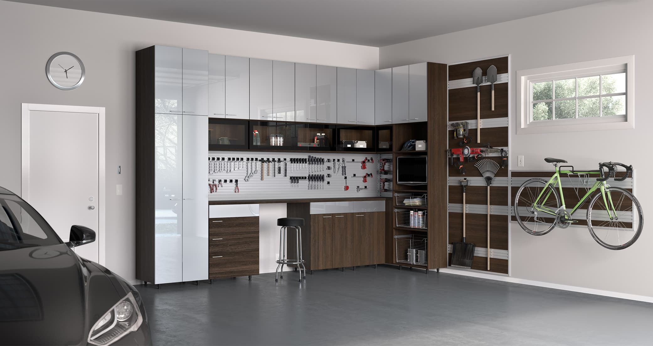 Workbench surrouned by garage storage cabinets in a dark finish by California Closets
