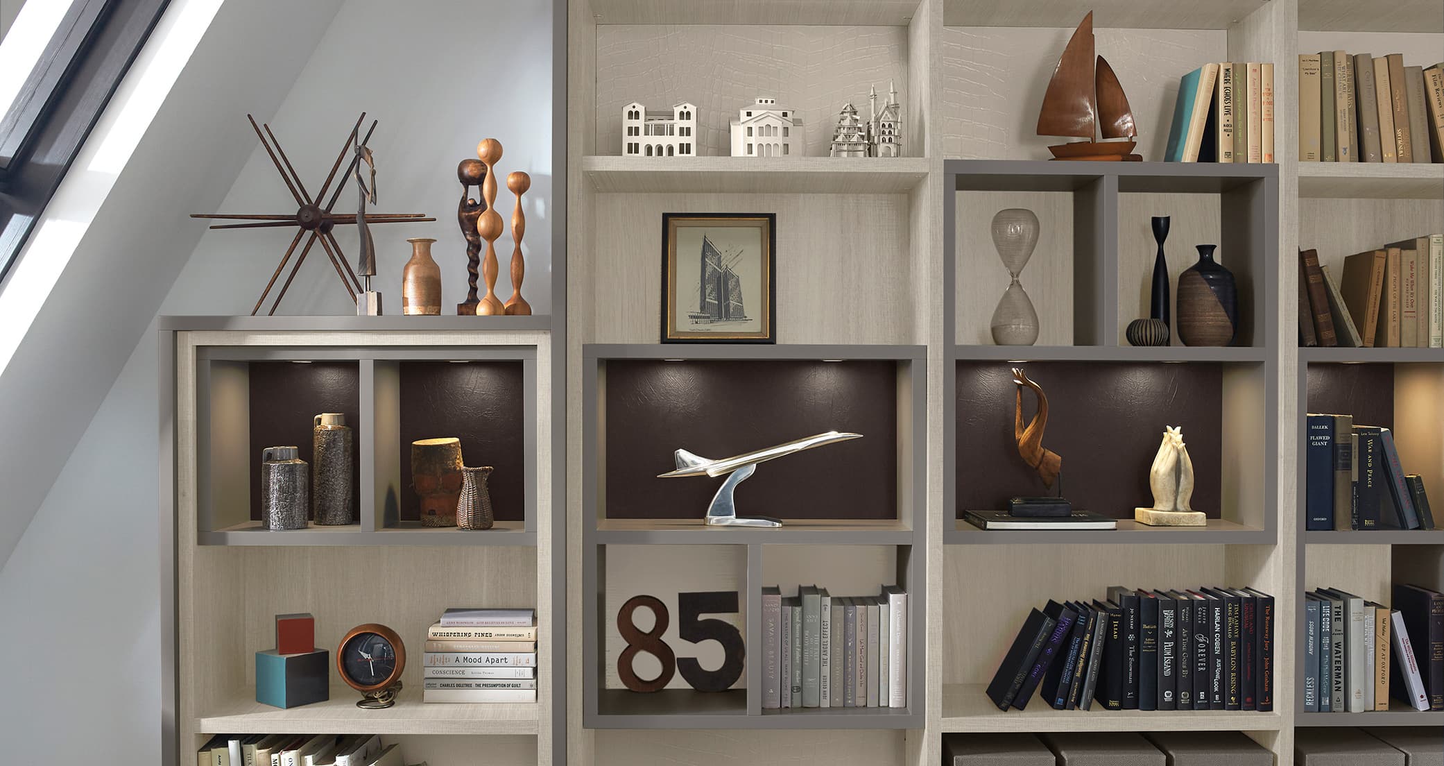 Office with library bookshelves built in designed in natural wood grain finish by California Closets