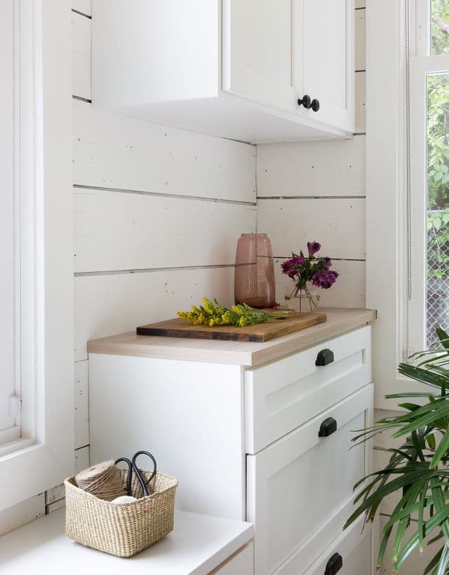 Camille Styles pantry storage cabinets and window bench storage by California Closets