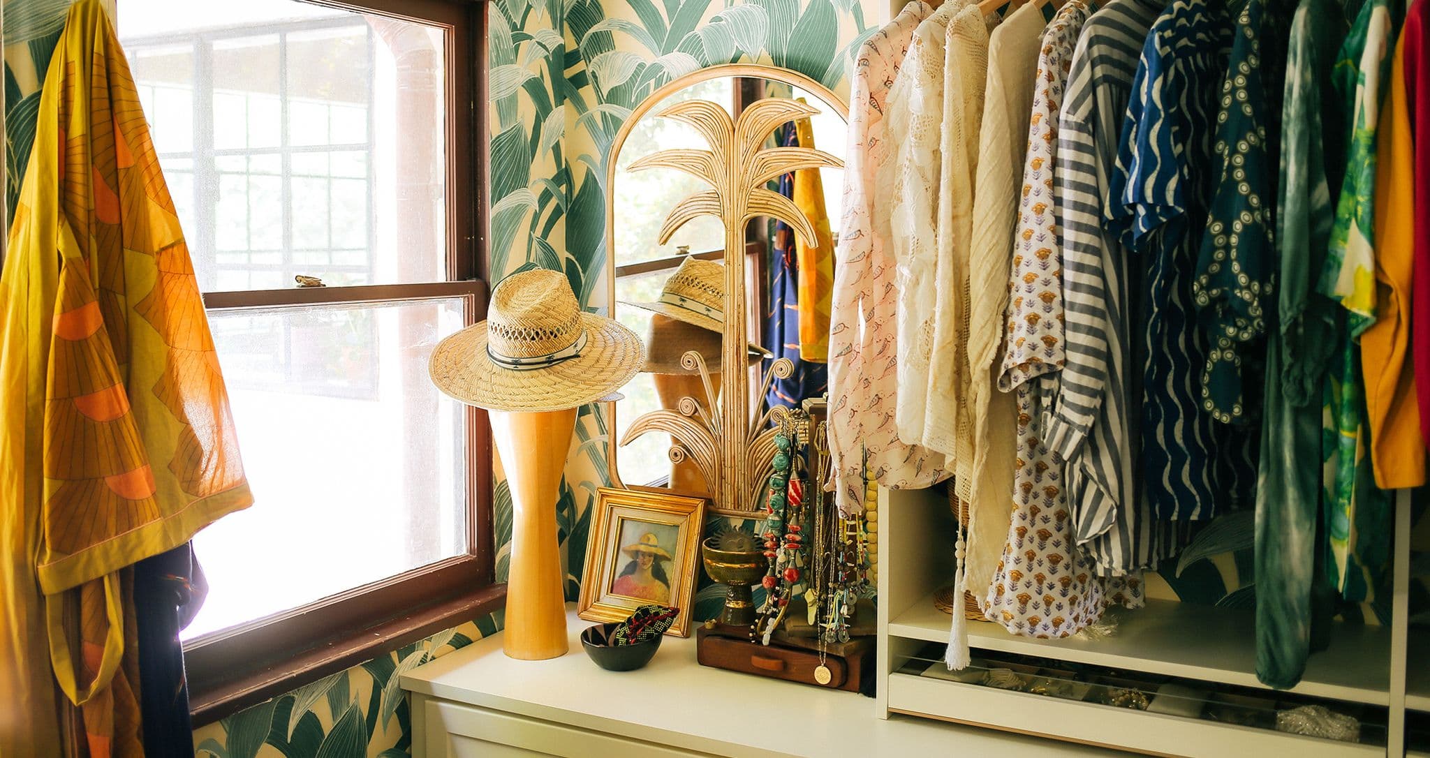 Jungalow founder Justina Blakeney's walk in closet with built in dresser drawers and vanity by California Closets