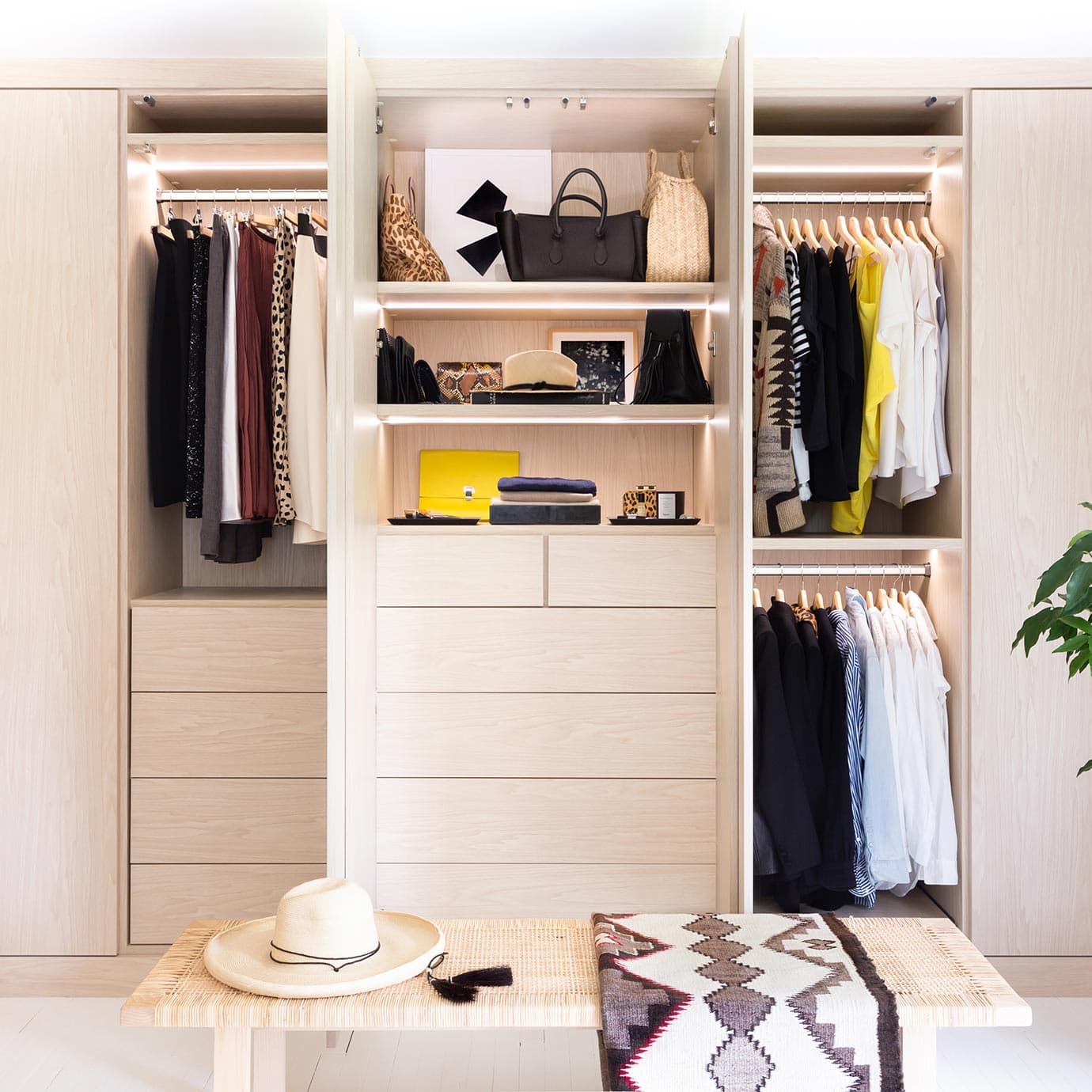 Custom drawer in a light wood finish with lighting California Closets