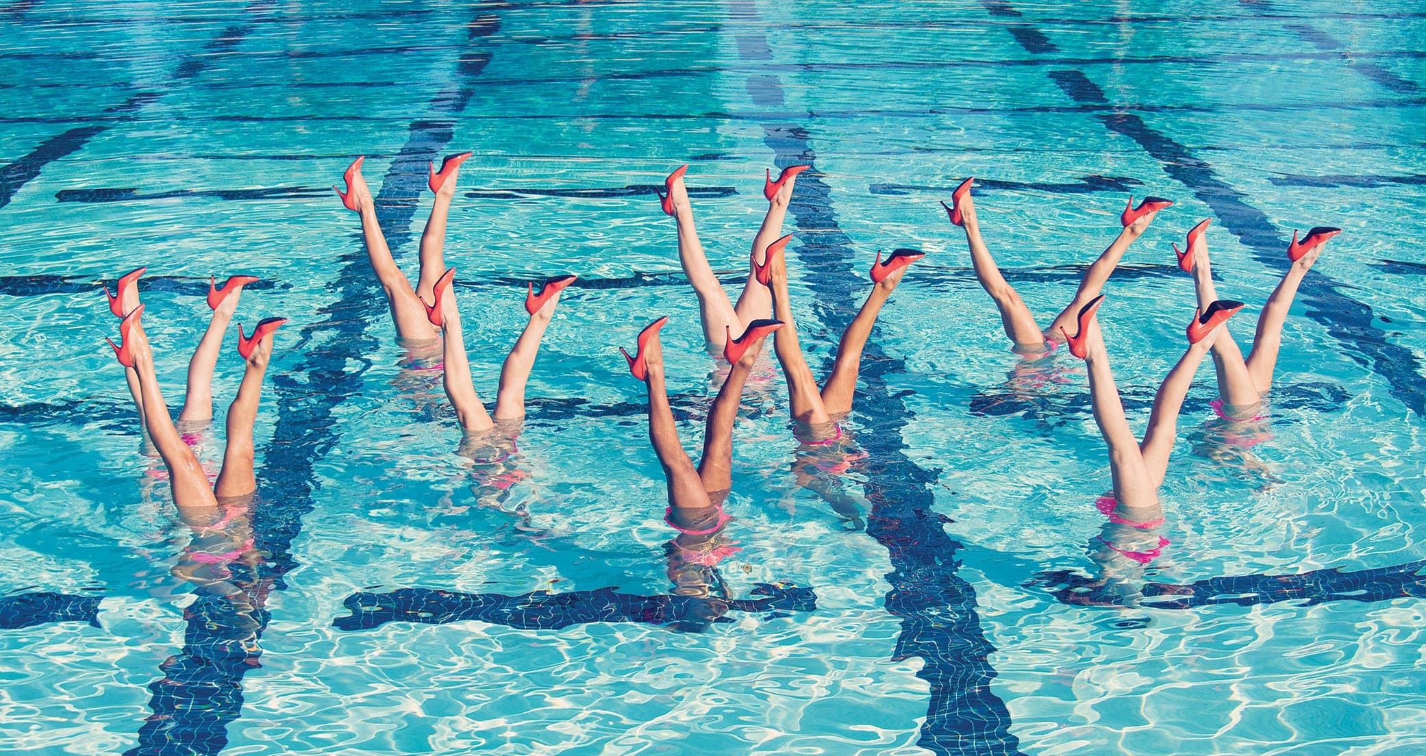 Swimmers in pool synchronized water daners wearing high heels in Ideas of Order Magazine