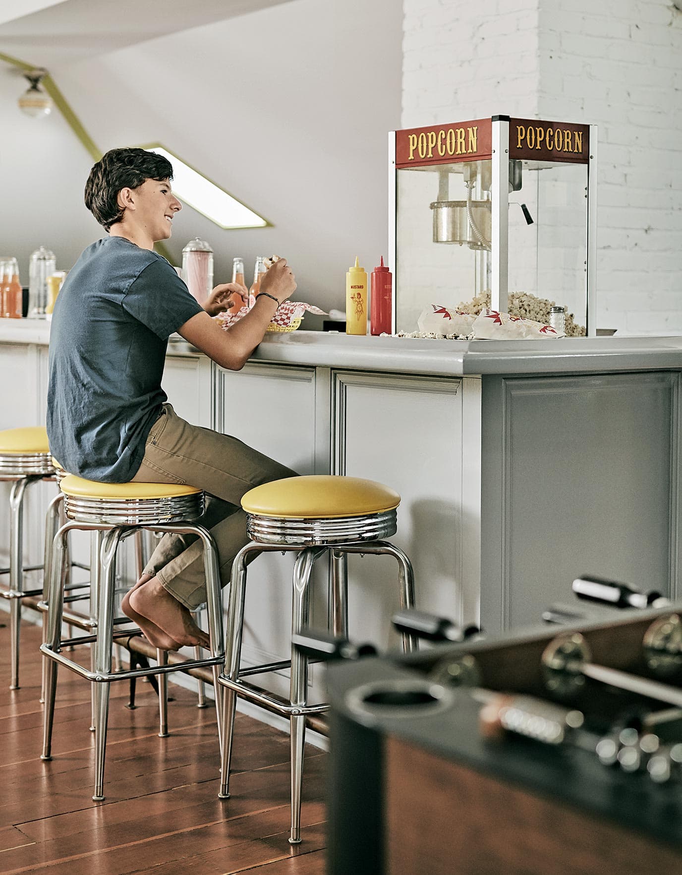 Cool hangout space for Lily Kanter's family home with bar stooks, counter and diner feel as told to Ideas of Order Magazine