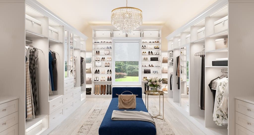 Luxe walk in closet with shoe storage, custom cabinets and open shelving by California Closets