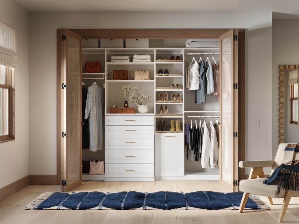 Reach in closet built with dresser drawers and open shelves to floor storage by California Closets